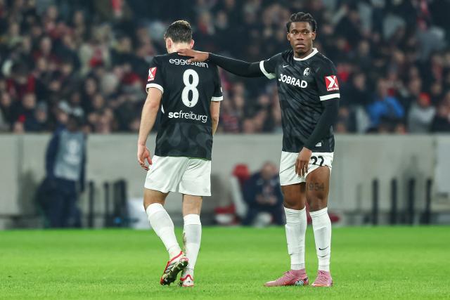 SC Freiburg's Burkinabe forward #22 Cyriaque Irie (R) comforts his teammate SC Freiburg's German midfielder #08 Maximilian Eggestein as he leaves the match after receiving a red card during the UEFA Europa League - League phase, Matchday 8 - football match between LOSC Lille and SC Freiburg at the Pierre Mauroy Stadium in Villeneuve d'Ascq, northern France, on January 29, 2026. (Photo by Sameer Al-DOUMY / AFP)