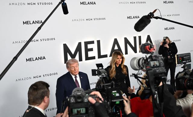 US President Donald Trump and US First Lady Melania Trump speak to journalists as they attend the world premiere of Amazon MGM Studios' "Melania" at the Kennedy Center in Washington, DC, on January 29, 2026. (Photo by Alex WROBLEWSKI / AFP)