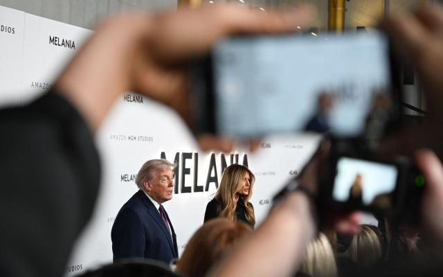 US President Donald Trump and US First Lady Melania Trump speak to journalists as they attend the world premiere of Amazon MGM Studios' "Melania" at the Kennedy Center in Washington, DC, on January 29, 2026. (Photo by Alex WROBLEWSKI / AFP)