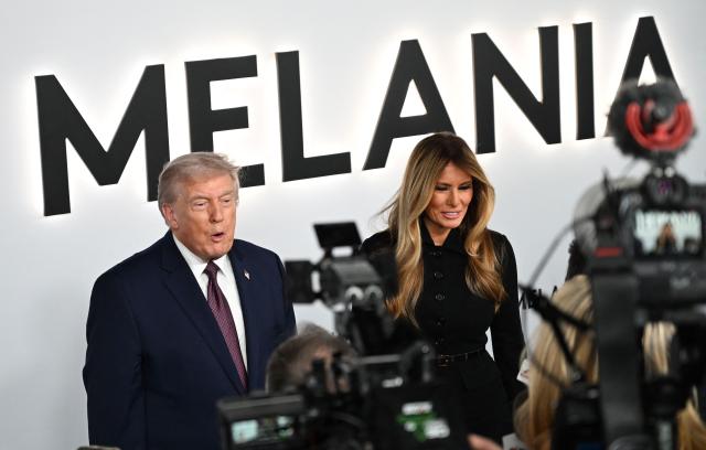 US President Donald Trump and US First Lady Melania Trump speak to journalists as they attend the world premiere of Amazon MGM Studios' "Melania" at the Kennedy Center in Washington, DC, on January 29, 2026. (Photo by Alex WROBLEWSKI / AFP)