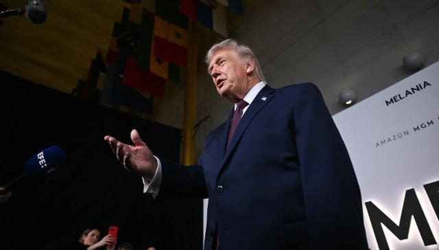 US President Donald Trump speaks to journalists as he attends the world premiere of Amazon MGM Studios' "Melania" at the Kennedy Center in Washington, DC, on January 29, 2026. (Photo by Brendan SMIALOWSKI / AFP)