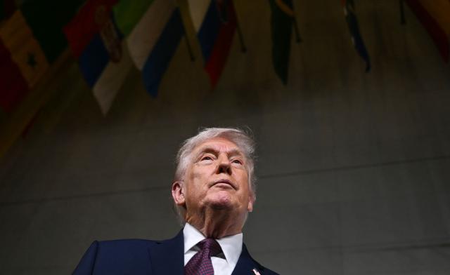 US President Donald Trump speaks to journalists as he attends the world premiere of Amazon MGM Studios' "Melania" at the Kennedy Center in Washington, DC, on January 29, 2026. (Photo by Brendan SMIALOWSKI / AFP)