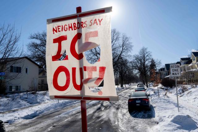 A banner to protest against US Immigration and Customs Enforcement (ICE) is seen at the entrance of a neighborhood in Minneapolis, Minnesota, on January 29, 2026. US President Donald Trump's border chief Tom Homan said on January 29 that some federal agents could be withdrawn from Minneapolis, the northern US city that has become the flashpoint for the president's immigration crackdown. The Trump administration, facing a public backlash over the shooting deaths of two Americans by federal agents in Minneapolis, also eased immigration operations in the northeastern state of Maine. (Photo by ROBERTO SCHMIDT / AFP)