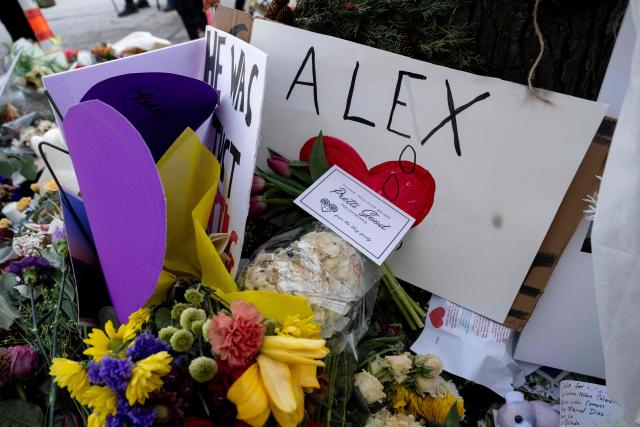 Notes and flowers left by mourners are seen at the makeshift memorial for Alex Pretti, set up in the area where he was recently shot and killed by federal immigration agents in Minneapolis, Minnesota, on January 29, 2026. US President Donald Trump's border chief Tom Homan said on January 29 that some federal agents could be withdrawn from Minneapolis, the northern US city that has become the flashpoint for the president's immigration crackdown. The Trump administration, facing a public backlash over the shooting deaths of two Americans by federal agents in Minneapolis, also eased immigration operations in the northeastern state of Maine. (Photo by ROBERTO SCHMIDT / AFP)