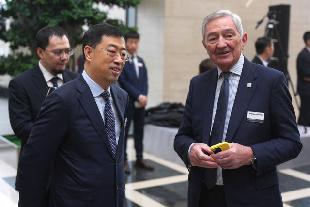 Chinese Communist Party Committee Secretary of the Bank of China Ge Haijiao (L) talks with HSBC Group Chairman Brendan Nelson during the UK-China Business Forum at the Bank of China in Beijing on January 30, 2026. Britain's Prime Minister Keir Starmer's visit to China is the first by a British premier since 2018 and follows a slew of Western leaders seeking a rapprochement with Beijing recently, pivoting from an increasingly unpredictable United States. (Photo by Carl Court / POOL / AFP)