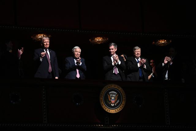 US President Donald Trump (L) reacts to the guests' applause while attending the world premiere of Amazon MGM Studios' "Melania" at the Kennedy Center in Washington, DC, on January 29, 2026. (Photo by Brendan SMIALOWSKI / AFP)