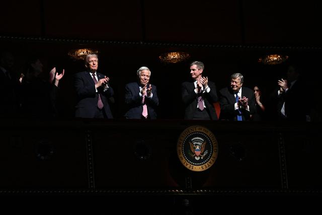US President Donald Trump (L) and guests applaud while attending the world premiere of Amazon MGM Studios' "Melania" at the Kennedy Center in Washington, DC, on January 29, 2026. (Photo by Brendan SMIALOWSKI / AFP)