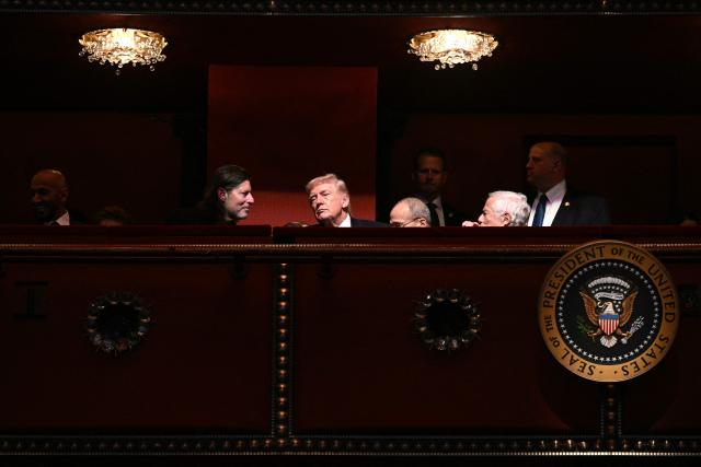 US President Donald Trump (C) chats with guests while attending the world premiere of Amazon MGM Studios' "Melania" at the Kennedy Center in Washington, DC, on January 29, 2026. (Photo by Brendan SMIALOWSKI / AFP)