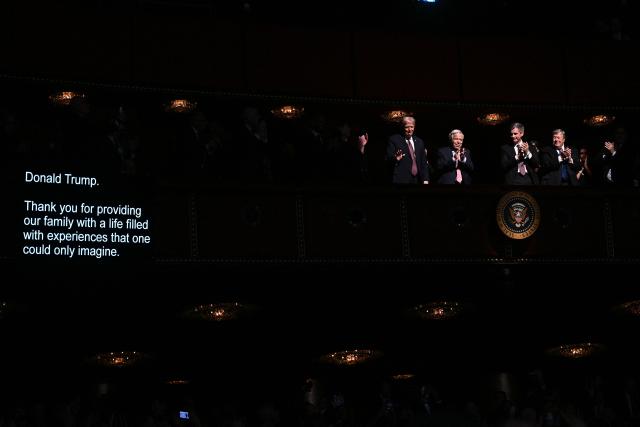 The telepromter shows the words being read by US First Lady Melania Trump (out of frame) as US President Donald Trump (L) is applauded by guests during the world premiere of Amazon MGM Studios' "Melania" at the Kennedy Center in Washington, DC, on January 29, 2026. (Photo by Brendan SMIALOWSKI / AFP)
