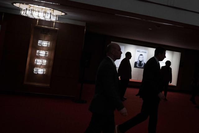 Attendees walk past movie posters while attending the world premiere of Amazon MGM Studios' "Melania" at the Kennedy Center in Washington, DC, on January 29, 2026. (Photo by Brendan Smialowski / AFP)