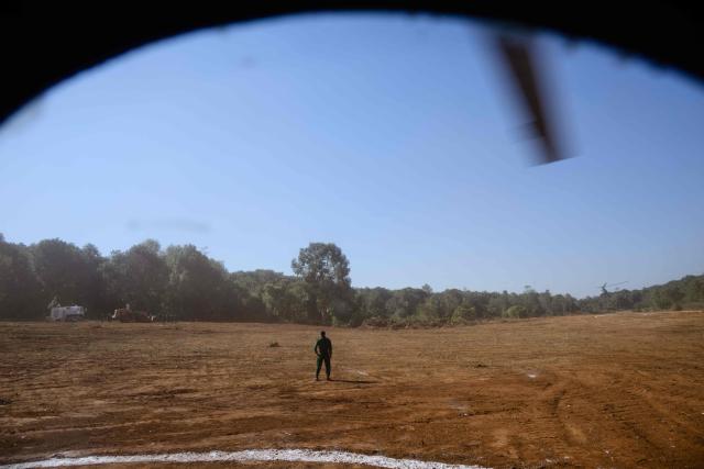 In this photo taken on January 24, 2026, a soldier is seen standing guard from the window of a military Mi-17 helicopter transporting a press tour of a drug production site southwest of Mongyai, northern Shan State, that was captured by the Myanmar military. The Southeast Asian country has long been a hive for illegal drug trade, but analysts say the civil war triggered by a 2021 military coup has increased production and trafficking. (Photo by ANTHONY WALLACE / AFP)