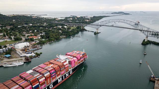 (FILES) This aerial view shows the Taiwanese cargo ship Yang Ming sailing out of the Panama Canal on the Pacific side in Panama City on October 6, 2025. The Panamanian Supreme Court annulled the concession whereby Hong Kong company CK Hutchison Holdings operates two ports on the Panama Canal, the court announced on January 29, 2026, following threats by US President Donald Trump to reclaim the waterway, claiming that it is controlled by China. (Photo by MARTIN BERNETTI / AFP)