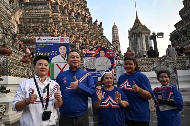 Former snooker player Wattana Pu-Ob-Orm (2nd L), known professionally as James Wattana), campaigns for the United Thai Nation Party with fellow MP candidate Kanyavee Jarusamphankanok (L) ahead of the general election in Bangkok on January 29, 2026. (Photo by Lillian SUWANRUMPHA / AFP)