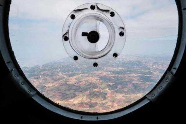 In this photo taken on January 24, 2026, a general view is seen from a military Mi-17 helicopter transporting members of the press to a tour of a drug production site in northern Shan State that was captured by the Myanmar military. The Southeast Asian country has long been a hive for illegal drug trade, but analysts say the civil war triggered by a 2021 military coup has increased production and trafficking. (Photo by ANTHONY WALLACE / AFP)