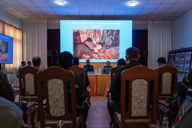 In this photo taken on January 24, 2026, Major-General Zaw Min Tun (centre L) speaks next to Chief of the Myanmar Police Force, Win Zaw Moe (centre R), during a briefing at Anisakan Airbase in Pyin Oo Lwin, before a press tour of a drug production site southwest of Mongyai, northern Shan State, that was captured by the Myanmar military. The Southeast Asian country has long been a hive for illegal drug trade, but analysts say the civil war triggered by a 2021 military coup has increased production and trafficking. (Photo by ANTHONY WALLACE / AFP)