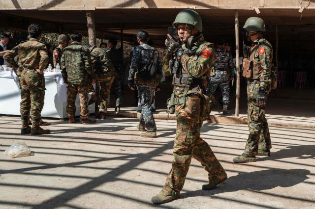 TOPSHOT - In this photo taken on January 24, 2026, soldiers walk around a makeshift hut during a press tour of a drug production site southwest of Mongyai, northern Shan State, that was captured by the Myanmar military. The Southeast Asian country has long been a hive for illegal drug trade, but analysts say the civil war triggered by a 2021 military coup has increased production and trafficking. (Photo by ANTHONY WALLACE / AFP)