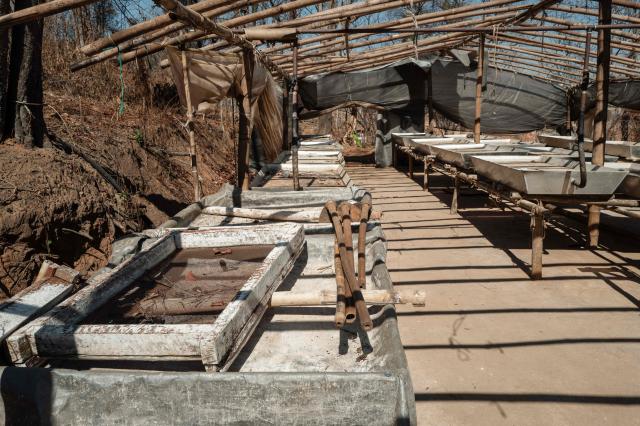 In this photo taken on January 24, 2026, processing trays are seen under a makeshift shelter during a press tour of a drug production site southwest of Mongyai, northern Shan State, that was captured by the Myanmar military. The Southeast Asian country has long been a hive for illegal drug trade, but analysts say the civil war triggered by a 2021 military coup has increased production and trafficking. (Photo by ANTHONY WALLACE / AFP)
