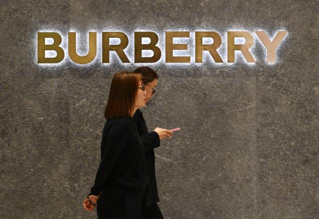 Women walk past a British Burberry shop at a shopping mall in Beijing on January 30, 2026. (Photo by ADEK BERRY / AFP)