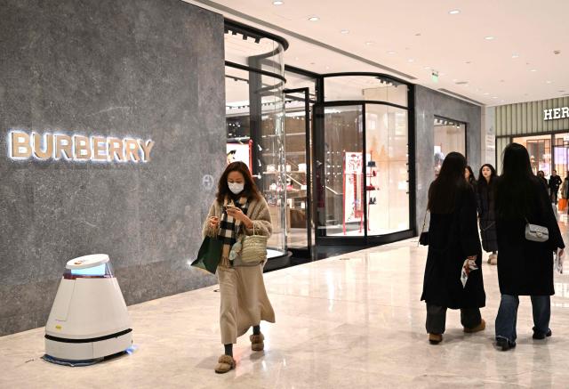 People walk past a British Burberry shop at a shopping mall in Beijing on January 30, 2026. (Photo by ADEK BERRY / AFP)