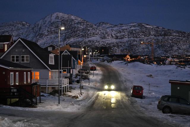 A car drives in a street in a residential area of Nuuk, Greenland on January 29, 2026. (Photo by Ina FASSBENDER / AFP)