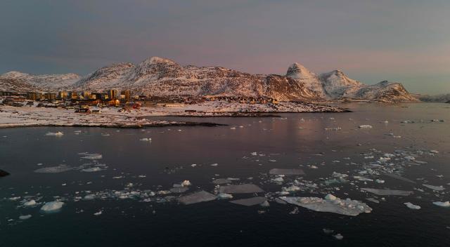 An aerial view shows  ice blocks in the water near the coastline of the city of Nuuk, Greenland on January 29, 2026. (Photo by Ina FASSBENDER / AFP)