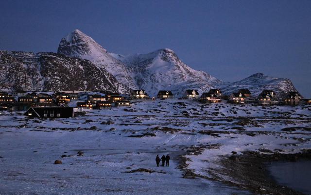 People walk in a residential area of Nuuk, Greenland on January 29, 2026. (Photo by Ina FASSBENDER / AFP)