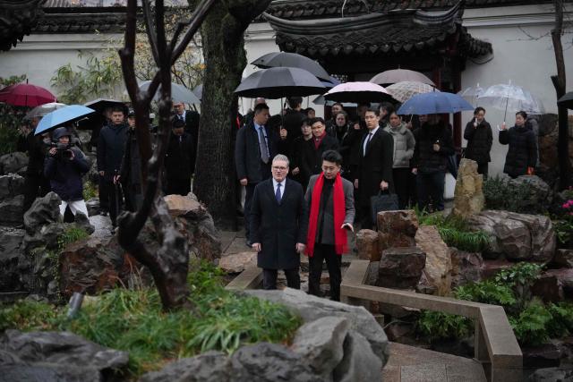 Britain's Prime Minister Keir Starmer (center-L) visits Yuyuan Gardens in Shanghai on January 30, 2026. (Photo by Kin Cheung / POOL / AFP)