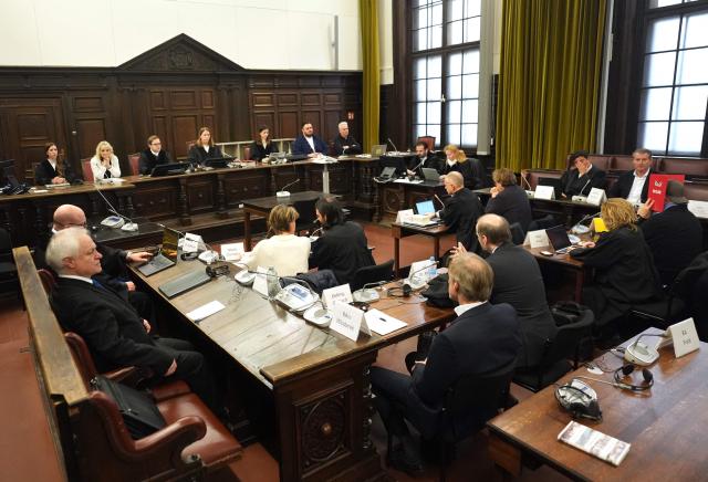 Presiding judge Isabel Hildebrandt (background, C) opens another session in the trial against defendant German entrepreneur and gastronome Christina Block (C-L, white jumper) sitting next to her lawyer Ingo Bott over alleged child abduction at the District Court in Hamburg, northern Germany, on January 30, 2026. The public prosecutor's office accuses Block, heiress of a steakhouse chain, of ordering the abduction of her daughter, born in 2010, and her son, born in 2013. According to the indictment, the background to this is an escalating custody dispute over many years between Block and her former husband, who have four children together. (Photo by Marcus Brandt / POOL / AFP)