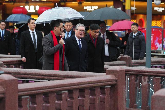 Britain's Prime Minister Keir Starmer (R) visits Yuyuan Gardens in Shanghai on January 30, 2026. (Photo by Carl Court / POOL / AFP)