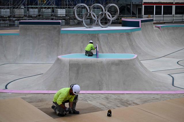 (FILES) Workers carry on works at the under construction skatepark for the upcoming Paris 2024 Olympics at La Concorde Urban Parc site in Paris on July 3, 2024. Construction companies face trial starting February 2, 2026 a the courthouse in Bobigny, suburb of Paris, for employing undocumented workers on construction sites for Paris 2024 Olympic Games. (Photo by JULIEN DE ROSA / AFP)
