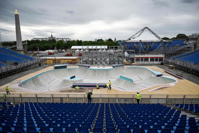 (FILES) A general view shows workers carrying on works at the under construction skatepark for the upcoming Paris 2024 Olympics at La Concorde Urban Parc site in Paris on July 3, 2024. Construction companies face trial starting February 2, 2026 a the courthouse in Bobigny, suburb of Paris, for employing undocumented workers on construction sites for Paris 2024 Olympic Games. (Photo by JULIEN DE ROSA / AFP)
