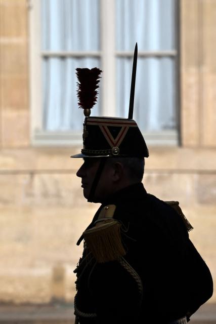 This photograph shows a silhouette of a French Republican Guards at the Elysee Palace in Paris on January 30, 2026. (Photo by Ludovic MARIN / AFP)