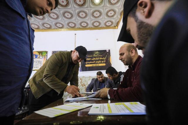 Men register to join the so-called “Martyrs’ Brigades” under the umbrella of Iraq's pro-Iran armed group Harakat al-Nujaba, which called on Iraqis to volunteer to fight alongside Iran in the event of a full-scale war with the United States and Israel, in Hillah on January 30, 2026. Iran threatened on January 30, to instantly strike US bases and aircraft carriers in response to any attack, after the US president warned time was running out for Tehran and the EU blacklisted its Revolutionary Guards as a terror group. (Photo by Karrar Jabbar / AFP)