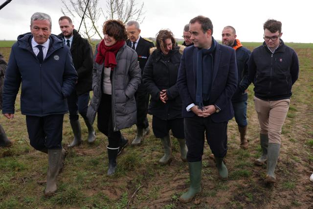 Les Democrates' MP Philippe Vigier (L) France's Prime Minister Sebastien Lecornu (3r R), and France's Agriculture Minister Annie Genevard (3rd L) tour an almond orchard during a visit to promote local and diversified agriculture, in Baigneaux, central France, on January 30, 2026. The prime minister is visiting the Eure-et-Loire department to launch the "contracts for the future" demanded by the Jeunes Agriculteurs (Young Farmers) union, aimed at diversifying production, notably in the face of climate change, and to present the Governments efforts to increase the share of local food in public procurement. (Photo by Thomas SAMSON / AFP)
