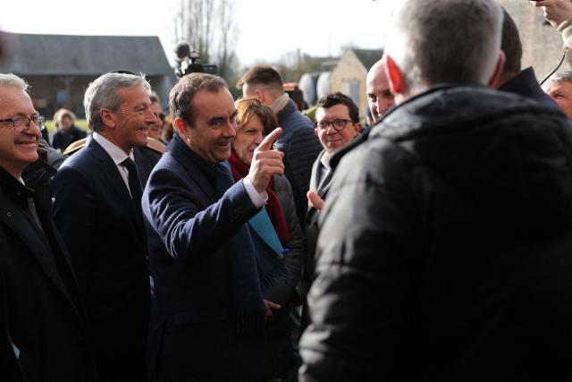 (From L) Centre-Val de Loire region president Francois Bonneau, Les Democrates' MP Philippe Vigier, France's Prime Minister Sebastien Lecornu and France's Agriculture Minister Annie Genevard are welcomed as they arrive to a farm during a visit to promote local and diversified agriculture, in Baigneaux, central France, on January 30, 2026. The prime minister is visiting the Eure-et-Loire department to launch the "contracts for the future" demanded by the Jeunes Agriculteurs (Young Farmers) union, aimed at diversifying production, notably in the face of climate change, and to present the Governments efforts to increase the share of local food in public procurement. (Photo by Thomas SAMSON / AFP)