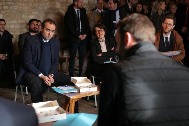 France's Prime Minister Sebastien Lecornu (L) and France's Agriculture Minister Annie Genevard (C) attend a meeting with agricultural sector representatives during a visit to promote local and diversified agriculture, in Baigneaux, central France, on January 30, 2026. The prime minister is visiting the Eure-et-Loire department to launch the "contracts for the future" demanded by the Jeunes Agriculteurs (Young Farmers) union, aimed at diversifying production, notably in the face of climate change, and to present the Governments efforts to increase the share of local food in public procurement. (Photo by Thomas SAMSON / AFP)