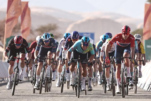 XDS Astana Team italian Matteo Malucelli (C) and Lidl-Trek cycling team's Italian Jonathan Milan (R) sprint toward the finish ligne in the fourth stage of the AlUla Tour cycling race, 173,4 km from Winter Park to Hegra on January 30, 2026. (Photo by Anne-Christine POUJOULAT / AFP)