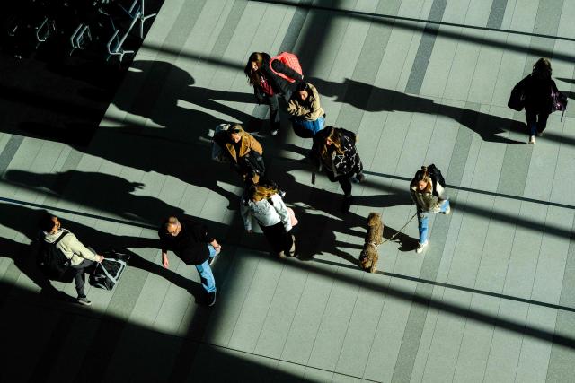 Passengers walk in a terminal at LaGuardia airport in New York City on January 30, 2026. (Photo by CHARLY TRIBALLEAU / AFP)