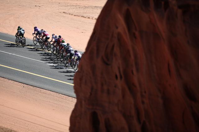 The pack competes in the fourth stage of the AlUla Tour cycling race, 173,4 km from Winter Park to Hegra on January 30, 2026. (Photo by Anne-Christine POUJOULAT / AFP)