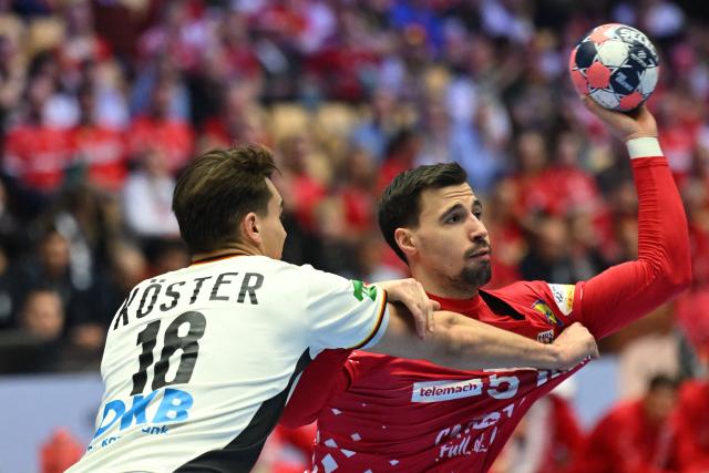 Germany's left back #18 Julian Koster and Croatia's right back #51 Ivan Martinovic vie for the ball during the men's EHF Euro 2026 semi-finals handball match Germany vs Croatia in Herning, Denmark, on January 30, 2026. (Photo by Jonathan Nackstrand / AFP)
