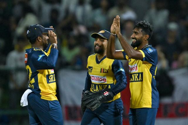Sri Lanka's Eshan Malinga (R) celebrates with teammates after taking the wicket of England's Jos Buttler (not pictured) during the first Twenty20 international cricket match between Sri Lanka and England at the Pallekele International Cricket Stadium in Kandy on January 30, 2026. (Photo by Ishara S. KODIKARA / AFP)