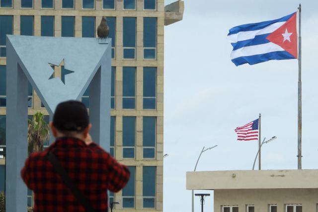 A tourist takes pictures of the US Embassy with the US flag and the Cuban flag in the background in Havana on January 30, 2026. Cuban President Miguel Diaz-Canel on January 30, 2026, denounced US President Donald Trump’s attempt to “asphyxiate” the communist island’s economy under a “false pretext.” (Photo by ADALBERTO ROQUE / AFP)