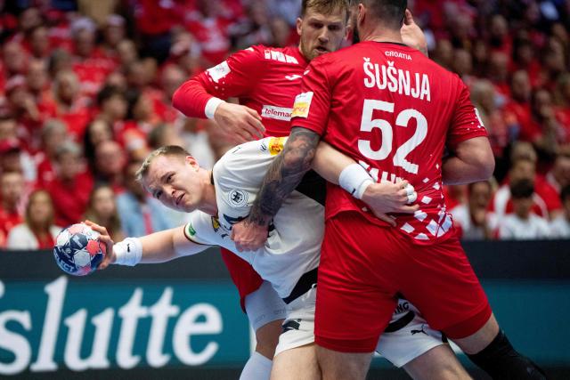 Germany's pivot #54 Justus Fischer and Croatia's left back #38 Ante Ivankovic  and Croatia's pivot #52 Leon Susnja vie for the ball during the men's EHF Euro 2026 semi-finals handball match Germany vs Croatia in Herning, Denmark, on January 30, 2026. (Photo by Bo Amstrup / Ritzau Scanpix / AFP) / Denmark OUT