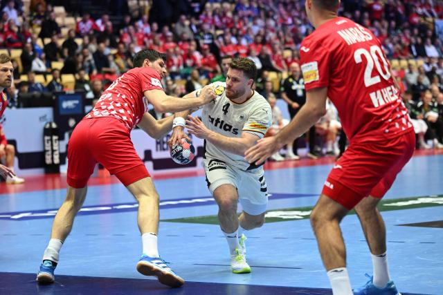 Germany's pivot #04 Johannes Golla vies for the ball during the men's EHF Euro 2026 semi-finals handball match Germany vs Croatia in Herning, Denmark, on January 30, 2026. (Photo by Jonathan Nackstrand / AFP)