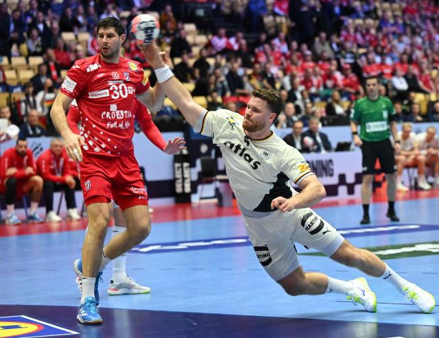Germany's pivot #04 Johannes Golla shoots during the men's EHF Euro 2026 semi-finals handball match Germany vs Croatia in Herning, Denmark, on January 30, 2026. (Photo by Jonathan Nackstrand / AFP)