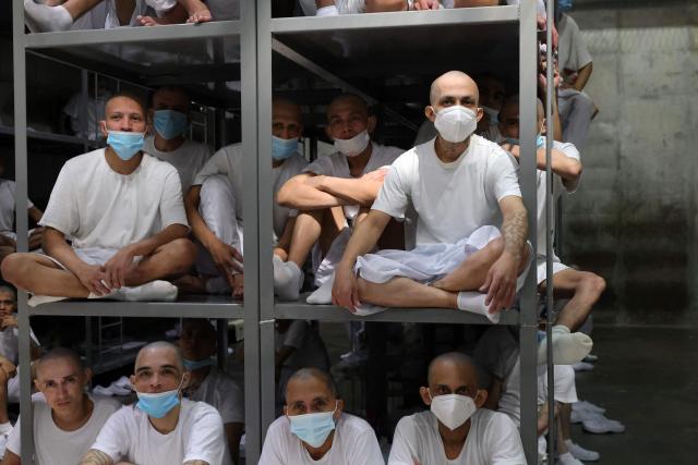Inmates remain in a cell during a visit by Chile’s president-elect Jose Antonio Kast (out of frame) to the Counter-Terrorism Confinement Centre (CECOT) mega-prison, where hundreds of MS-13 and 18th Street gang members are being held, in Tecoluca, El Salvador, on January 29, 2026. The CECOT, the largest prison in Latin America and emblem of the war against gangs of the government of President Nayib Bukele, celebrates two years since it was inaugurated on February 1. (Photo by Oscar RIVERA / AFP)