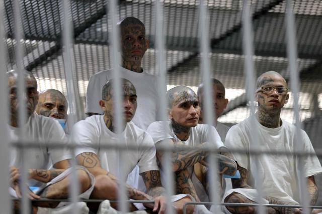 Inmates remain in a cell during a visit by Chile’s president-elect Jose Antonio Kast (out of frame) to the Counter-Terrorism Confinement Centre (CECOT) mega-prison, where hundreds of MS-13 and 18th Street gang members are being held, in Tecoluca, El Salvador, on January 29, 2026. The CECOT, the largest prison in Latin America and emblem of the war against gangs of the government of President Nayib Bukele, celebrates two years since it was inaugurated on February 1. (Photo by Oscar RIVERA / AFP)