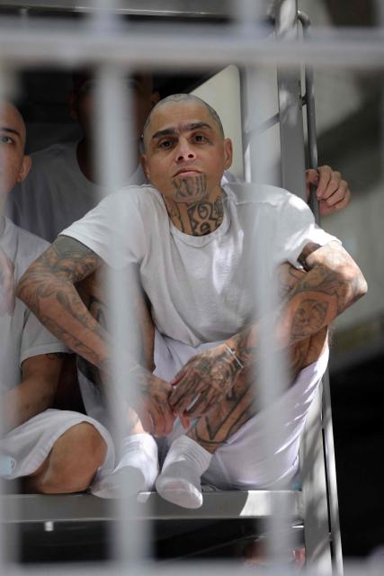 An inmate remains in a cell during a visit by Chile’s president-elect Jose Antonio Kast (out of frame) to the Counter-Terrorism Confinement Centre (CECOT) mega-prison, where hundreds of MS-13 and 18th Street gang members are being held, in Tecoluca, El Salvador, on January 29, 2026. The CECOT, the largest prison in Latin America and emblem of the war against gangs of the government of President Nayib Bukele, celebrates two years since it was inaugurated on February 1. (Photo by Oscar RIVERA / AFP)