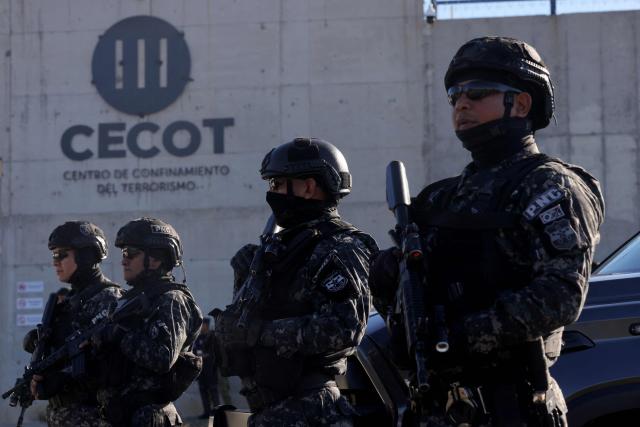 National Civil Police (PNC) officers stand guard before the arrival of Chile's president-elect Jose Antonio Kast at the Counter-Terrorism Confinement Center (CECOT) mega-prison, where hundreds of MS-13 and 18th Street gang members are being held, in Tecoluca, El Salvador, on January 29, 2026. The CECOT, the largest prison in Latin America and emblem of the war against gangs of the government of President Nayib Bukele, celebrates two years since it was inaugurated on February 1. (Photo by Oscar Rivera / AFP)