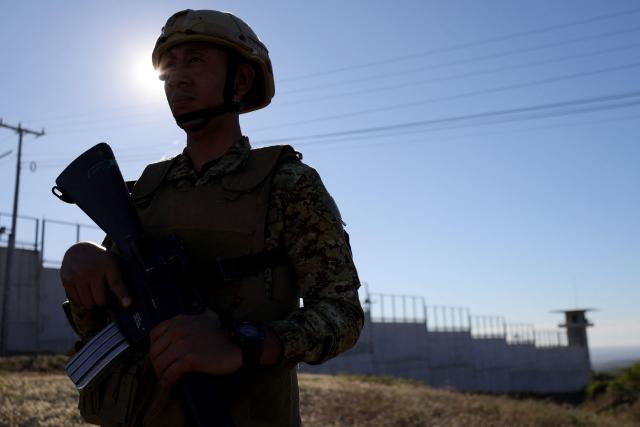 A soldier stands guard before the arrival of Chile's president-elect Jose Antonio Kast at the Counter-Terrorism Confinement Center (CECOT) mega-prison, where hundreds of MS-13 and 18th Street gang members are being held, in Tecoluca, El Salvador, on January 29, 2026. The CECOT, the largest prison in Latin America and emblem of the war against gangs of the government of President Nayib Bukele, celebrates two years since it was inaugurated on February 1. (Photo by Oscar Rivera / AFP)